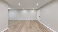 Located at 1229 Pericles Pl in Whitehall, PA, this single-floor, two-bedroom, two-bathroom residence offers a well-designed layout with contemporary finishes throughout. The living area greets residents with light wood-tone luxury vinyl plank flooring, recessed lighting, and a neutral gray-toned palette that creates a clean, modern ambiance. A distinctive pass-through window with a stone-accented ledge connects the living space to the kitchen, enhancing the open feel.

The kitchen is outfitted with crisp white shaker-style cabinetry, stone-look countertops, and a full suite of stainless steel appliances including a range, microwave, and refrigerator, complemented by matching light plank flooring for a seamless aesthetic.

Both bedrooms feature soft, neutral carpeting, ceiling fans, and windows fitted with white wood blinds that allow natural light while maintaining privacy. The generously sized primary bedroom includes a closet with double doors. The second bedroom offers a similarly comfortable footprint with its own window view.

The two bathrooms are finished with large-format neutral tile. One features a walk-in glass-enclosed shower with a built-in bench and rain-style showerhead, while the other includes a soaking tub with full tile surround. Both bathrooms showcase white vanities and chrome fixtures for a polished, cohesive look.