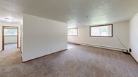 Located at 2809 #4 in Sioux Falls, SD, this single-floor, two-bedroom, one-bathroom unit offers a well-organized and functional layout. The interior features neutral white walls, warm wood trim accents, and consistent wall-to-wall carpeting throughout the main living areas and bedrooms, contributing to a cohesive and comfortable feel. Textured ceilings add a classic character to each room.

The spacious primary bedroom is generously sized and is accompanied by windows that allow natural light to filter in, providing views of the surrounding greenery. The second bedroom also features carpeted flooring and a large window with natural light. Both bedrooms offer dedicated closet spaces for ample storage.

The full bathroom is finished with tile flooring, a wood-trimmed vanity with storage, and a tub/shower combination. The kitchen is positioned centrally within the layout and is accessible from the hallway, facilitating an efficient flow throughout the unit.

Baseboard heating is present throughout the space, ensuring consistent warmth. Two separate hallways connect the various rooms, enhancing accessibility and privacy between living and sleeping areas. The unit's straightforward, practical design makes it a well-suited space for comfortable everyday living in Sioux Falls.