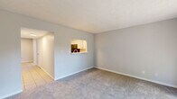 Located at 2910 White Knight Boulevard in Indianapolis, Indiana, this two-story home offers a practical and well-organized layout across two floors. The main level houses the living room, dining room, and kitchen, while the upper level accommodates the bedrooms and bathroom.

The living room features neutral gray carpet and a sliding glass door that opens to a fenced outdoor patio, allowing natural light to fill the space. Adjacent to the living room, the dining area features tile flooring and a ceiling fan with light fixture, adding comfort and function to the space. The kitchen is equipped with white cabinetry, marble-style countertops, a classic subway tile backsplash, a stainless steel sink, and black appliances including a refrigerator, electric range, and microwave. A window above the sink provides natural light.

Upstairs, the two bedrooms are finished with plush carpet and textured ceilings. The generously sized primary bedroom includes a closet and a window with blinds. The second bedroom is similarly appointed with carpet and a window overlooking the exterior. The full bathroom features wood-look vinyl flooring, a white vanity with a marble-style countertop, a tub-shower combo, and a louvered storage cabinet. A utility room and closet add practical storage throughout the home.