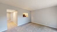 Located at 2910 White Knight Boulevard in Indianapolis, Indiana, this two-story home offers a practical and well-organized layout across two floors. The main level houses the living room, dining room, and kitchen, while the upper level accommodates the bedrooms and bathroom.

The living room features neutral gray carpet and a sliding glass door that opens to a fenced outdoor patio, allowing natural light to fill the space. Adjacent to the living room, the dining area features tile flooring and a ceiling fan with light fixture, adding comfort and function to the space. The kitchen is equipped with white cabinetry, marble-style countertops, a classic subway tile backsplash, a stainless steel sink, and black appliances including a refrigerator, electric range, and microwave. A window above the sink provides natural light.

Upstairs, the two bedrooms are finished with plush carpet and textured ceilings. The generously sized primary bedroom includes a closet and a window with blinds. The second bedroom is similarly appointed with carpet and a window overlooking the exterior. The full bathroom features wood-look vinyl flooring, a white vanity with a marble-style countertop, a tub-shower combo, and a louvered storage cabinet. A utility room and closet add practical storage throughout the home.