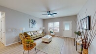 Located at 3332 Dry Stream Rd in Wentzville, Missouri, this single-story home offers a thoughtfully designed layout with a bright, welcoming atmosphere throughout. The living room serves as the heart of the space, featuring light wood-style flooring, neutral gray walls, and a ceiling fan overhead. Natural light flows in through multiple windows flanking the front entry door, creating an airy, open feel well-suited for both relaxing and entertaining.

The kitchen is a functional highlight, equipped with warm honey-toned cabinetry extending to the ceiling, granite countertops, a white subway tile backsplash, and stainless steel appliances. A central island with matching granite provides additional prep and dining space, complementing the kitchen's practical yet polished design.

The bedrooms are carpeted for comfort, each receiving ample natural light through large windows. The primary bedroom offers generous space, while the secondary bedroom comfortably accommodates multiple beds. Both bathrooms feature wood-toned vanity cabinetry, white countertops, light wood-style flooring, and tub-shower combinations, maintaining a clean and cohesive aesthetic consistent with the rest of the home.