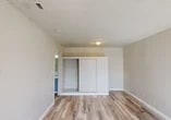 Located at 73 Brookdale Dr in Merced, California, this single-story, one-bedroom, one-bathroom unit offers a practical and efficiently designed layout across a single floor. Light-toned vinyl plank flooring runs throughout, lending a clean, cohesive look to the entire space.

The living area greets you at the entrance with a large front-facing window that allows natural light to pour in, creating a bright and welcoming atmosphere. The textured popcorn ceiling and neutral beige walls maintain a simple, understated aesthetic throughout.

The kitchen is well-appointed with gray lower and upper cabinetry providing ample storage, white laminate countertops, a built-in sink, and white appliances including an electric coil range, range hood, and refrigerator. The galley-style layout makes efficient use of the available space, with vinyl plank flooring continuing seamlessly from the main living areas.

The generously sized bedroom features a sliding double-door closet, a ceiling light fixture, and easy access to the adjacent bathroom. The textured ceiling and neutral tones carry through, keeping the room calm and functional.

The bathroom is equipped with a full-size tub and shower combo featuring white tile surround, a chrome towel bar, and standard fixtures, completing this straightforward and practical unit.