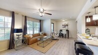 Located at 815 S Donaghey Ave in Conway, Arkansas, this one-bedroom, one-bathroom residence offers a thoughtfully designed single-floor layout that maximizes comfort and functionality. The living room serves as the heart of the home, featuring light wood-style flooring, a ceiling fan, and multiple large windows dressed with elegant drape panels that flood the space with natural light and offer pleasant outdoor views. The open flow connects the living area to a dedicated dining space, making it ideal for everyday living and entertaining.

The kitchen is well-equipped with rich dark wood cabinetry, light countertops, a full suite of black appliances including a range, microwave, dishwasher, and refrigerator, and ample storage throughout its U-shaped layout. Light flooring ties the kitchen seamlessly to the rest of the living areas.

The bedroom is a comfortable retreat featuring plush carpeting, a ceiling fan, a bright window with outdoor views, and convenient access to the closet. The bathroom features a large vanity with dark wood cabinetry, a wide mirror, and light countertops. A dedicated laundry area with in-unit washer and dryer connections is also accessible from the bathroom, adding a practical convenience to this well-rounded residence.