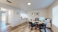 Located in Sacramento, CA (95821), this well-maintained single-floor space offers a cohesive, modern aesthetic defined by light wood-look flooring that runs seamlessly throughout. The layout, as revealed by the dollhouse view, is thoughtfully organized into distinct functional zones.

The office area is a standout feature, equipped with a spacious work desk, ergonomic seating, and guest chairs, making it well-suited for professional use. A pass-through window connects this area to an adjacent sink, adding a convenient utility element. Framed artwork on the crisp white walls adds a touch of polish.

The galley-style kitchen is efficiently designed, featuring white cabinetry on both sides, white appliances including a range and dishwasher, a stainless steel sink, and light countertops. A window at the end of the kitchen allows natural light to brighten the space.

A welcoming entry area provides a functional reception-style zone with wall-mounted hooks, a compact desk, and natural light filtering through a side window. The full bathroom is clean and straightforward, outfitted with a shower/tub combo and wood-look flooring consistent with the rest of the space.

An additional bright room features a sliding glass door that opens to a fenced outdoor area, allowing natural light to pour in and offering a refreshing connection to the exterior.