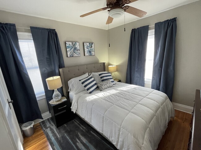 Master bedroom with bedding, closet, dresser, end tables & lamps - 514 Center St