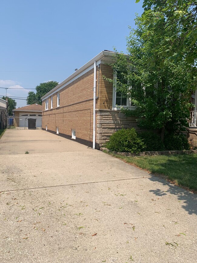 Side of Single Family Home with Driveway - 5212 S Oak Park Ave