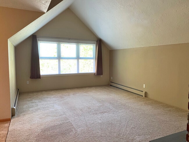 Vaulted living room with large windows including 2 inch blinds and black-out window curtains - 9604 SW Morrison St