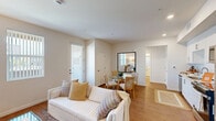 Located at 29986 Berea Road in Menifee, CA, this single-floor, one-bedroom, one-bathroom residence offers a thoughtfully designed layout with modern finishes throughout. The open-concept living, dining, and kitchen area forms the heart of the home, bathed in natural light from multiple windows fitted with vertical blinds. The living area features warm-toned hardwood-style flooring, recessed lighting, and a clean, neutral color palette that creates a bright and welcoming ambiance.

The kitchen is outfitted with crisp white cabinetry, a subway tile backsplash, stainless steel appliances including a refrigerator, range, microwave, and dishwasher, and ample counter space — seamlessly connecting to the dining area.

The bedroom is a comfortable retreat with windows offering natural light, hardwood-style flooring, and a relaxed, airy feel. The full bathroom features white shaker-style cabinetry, a large vanity mirror, and a shower-tub combination.

Additional highlights include two closets, a hallway, a dedicated utility room, and an in-unit laundry area, as well as a private balcony. The overall design emphasizes a clean, contemporary aesthetic with a warm and functional sensibility throughout every room.