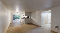Located at 8010 SW Avery St in Tualatin, Oregon, this single-floor, 2-bedroom, 1-bathroom residence offers a practical and comfortable layout. The open-concept living and dining area is finished with warm carpet and features a ceiling fan, with a sliding glass door that leads to a private patio overlooking mature, lush greenery. Natural light filters in through the large windows, creating a bright and welcoming atmosphere throughout.

The kitchen is efficiently designed with white cabinetry, dark countertops, and wood-style flooring. Black appliances — including a range, refrigerator, and dishwasher — are paired with a peninsula that doubles as a breakfast bar, seamlessly connecting the kitchen to the living and dining space.

Both bedrooms are carpeted and receive natural light through window blinds. The primary bedroom offers a comfortable footprint and closet storage with sliding doors. Additional closets throughout the home provide generous storage options.

The bathroom is clean and functional, featuring a full tub-shower combination with modern fixtures and wood-style flooring. A dedicated laundry area adds everyday convenience. A hallway connects the main living spaces to the bedrooms and bathroom, completing this well-organized single-level home.