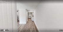 This contemporary 870 square foot apartment offers a thoughtful layout with two bedrooms and an open-concept living area. The kitchen is a highlight, boasting rich dark wood cabinetry, stainless steel appliances, and elegant granite countertops. A central island with a breakfast bar seamlessly connects the kitchen to the living room, enhancing the space's flow and functionality.

The living area is spacious and bright, with neutral-toned walls and plush carpeting. Large sliding glass doors lead to a private balcony, providing a serene outdoor space and filling the room with natural light. The primary bedroom, measuring 200 square feet, offers ample space and includes a closet with sliding doors for efficient storage.

Throughout the apartment, recessed lighting and modern ceiling fixtures provide a warm ambiance. The second bedroom, while smaller, is versatile and could serve as a home office or guest room. Both bedrooms feature windows that allow natural light to flood in, creating a bright and airy atmosphere.

The apartment's design prioritizes both style and practicality, with clean lines, a neutral color palette, and quality finishes that create a cohesive and inviting living space. This well-appointed home offers a perfect blend of comfort and modern urban living.