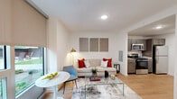 Located at 1320 Art Dilly Dr in Austin's dynamic 78702 neighborhood, this one-bedroom, one-bathroom unit offers a thoughtfully designed single-floor layout with modern finishes throughout. Light wood-tone flooring flows seamlessly across the open-concept living and kitchen areas, creating a cohesive and inviting atmosphere. The living room is bright and airy, benefiting from a large window with a roller shade that allows for flexible natural light control, while recessed lighting ensures the space remains well-lit at all times. The kitchen is efficiently appointed with dark gray cabinetry, granite countertops, stainless steel appliances — including a gas range, microwave, and refrigerator — and ample cabinet storage. A granite-topped peninsula provides additional prep space and a natural transition into the living area. The bedroom is a calm retreat featuring hardwood-style flooring, a ceiling fan, clean white walls, and enough room to comfortably accommodate a full-sized bed with nightstands. The bathroom continues the refined aesthetic with granite countertops, an undermount sink, and a framed mirror. Compact yet complete, this unit makes excellent use of every square foot, offering a clean, contemporary living experience in the heart of East Austin.