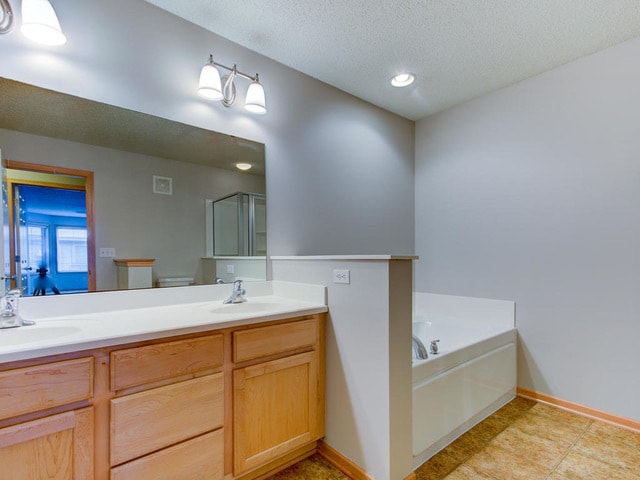 Bathroom with double vanity and soaking tub. - 11165 Kinsley St