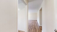 Located at 62 Manor Pkwy in Rochester, NY, this single-floor unit offers three bedrooms, one bathroom, a kitchen, a hallway, and an entrance within a compact and efficiently arranged floor plan. The layout is straightforward, with rooms connected via a central hallway.

The generously sized primary bedroom features warm, neutral-toned walls and smooth hardwood-style laminate flooring, lending it a clean and modern feel. The two additional bedrooms are finished with wall-to-wall carpeting in a neutral beige tone, providing a comfortable, cozy atmosphere. Each bedroom benefits from natural light through sizable windows fitted with blinds, offering both brightness and privacy. Several bedrooms also include closet access.

The kitchen is equipped with white cabinetry, a gas range, and dark laminate countertops. A window above the counter area allows natural light to fill the space while providing a view of the surrounding greenery outside.

The bathroom is finished in crisp white tones, featuring a vanity with storage, a toilet, and a window that brings in natural light while maintaining privacy.

Throughout the unit, warm beige walls create a consistent, neutral palette. The combination of laminate flooring in key areas and carpet in the bedrooms offers both practicality and comfort across this well-organized single-level home.