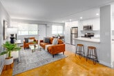 Located at 470 Scenic Dr in London, Ontario, this 2-bedroom, 1-bathroom unit offers a thoughtfully designed layout that makes excellent use of its space. The modern kitchen is a standout feature, boasting crisp white shaker cabinetry extending to the ceiling, stainless steel appliances including a fridge, electric range, built-in microwave, and dishwasher, as well as sleek granite countertops and a peninsula with bar seating — ideal for casual dining or entertaining. Light grey flooring in the kitchen transitions seamlessly into the classic parquet hardwood flooring found throughout the rest of the unit. The open-concept living room is bright and welcoming, with natural light streaming in through large windows that frame lush greenery outside. Both bedrooms are comfortably sized, each featuring parquet flooring, wide windows with outdoor views, and ample closet space — the primary bedroom includes a double-door closet. The bathroom is clean and functional, featuring a full tub-and-shower combination with white subway tile surround and chrome fixtures. Neutral tones and clean lines throughout the unit create a calm, cohesive atmosphere that is both practical and inviting.