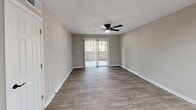 Located at 228 Morrow Rd in Forest Park, GA, this single-floor, one-bedroom, one-bathroom home offers a thoughtfully updated interior with a clean, modern aesthetic throughout. The combined kitchen and living area serves as the heart of the home, with the living room featuring durable hardwood-style flooring, neutral gray walls, white trim, a ceiling fan with light fixture, and a sliding glass door that fills the space with natural light and provides access to an outdoor area. The updated kitchen is equipped with gray shaker-style cabinetry, white countertops, a white subway tile backsplash, a stainless undermount sink with a matte black faucet, and black appliances including a refrigerator, range, and dishwasher. Light tile flooring and a skylight panel overhead keep the kitchen bright and functional. The bedroom offers plush carpeting, a ceiling fan, neutral walls, and a window with outdoor views, creating a comfortable and restful retreat. A hallway connects the main living spaces to the full bathroom, which features a tub-shower combination with crisp white tile surround and matte black fixtures. Clean lines and consistent neutral tones throughout lend the home a cohesive and move-in ready feel.