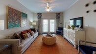 This single-story residence at 337 Savannah Hwy in Port Royal, South Carolina, presents a thoughtfully designed layout that balances open living with defined, comfortable spaces throughout. Dark hardwood-style flooring flows through the main living areas, creating a warm and cohesive aesthetic.

The kitchen is appointed with dark espresso cabinetry, granite countertops, subway tile backsplash, stainless steel appliances, and under-cabinet lighting. A central island with bar seating and pendant lighting connects the kitchen to the dining area, which features crown molding and a chandelier overhead.

The living room is bright and welcoming, with French doors that invite natural light and offer outdoor views. Crown molding, a ceiling fan, and neutral walls contribute to the room's relaxed, coastal-inspired character.

The bedrooms offer plush carpeting and generous wall space, with natural light filtering through slatted blinds. Both bathrooms are finished with granite-topped dark vanities, wood-style flooring, and tub-shower combinations with tile surrounds.

Overall, the residence conveys a cohesive, casual elegance suited to the laid-back coastal lifestyle of the Port Royal area.