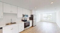 Located at 1001 Birdie Dr in Coraopolis, PA, this three-bedroom, two-bathroom home offers a thoughtfully designed single-floor layout with a clean, contemporary aesthetic. Light wood flooring runs consistently throughout the space, tying each room together with a warm, cohesive feel.

The kitchen is a standout feature, showcasing sleek white cabinetry that extends to the ceiling for generous storage, paired with light countertops and a full suite of stainless steel appliances including a refrigerator, electric range, built-in microwave, and dishwasher. The kitchen opens toward a windowed area, allowing natural light to fill the space.

A central hallway connects the three bedrooms and two full bathrooms, providing an efficient and functional flow. The primary bedroom is a comfortable, well-proportioned room with natural light streaming through a large window with views of surrounding greenery. The additional bedrooms feature the same warm wood flooring and crisp white walls. Both bathrooms are finished consistently, each offering a full tub-shower combination with white tile surround, recessed lighting, and wood-tone flooring. The overall design is modern, minimal, and move-in ready.