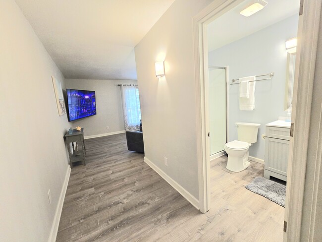 Walk the hall from the living room to the modern bathroom. - 206 Cordoba St