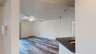 This 800 square foot apartment offers a well-designed living space with two bedrooms and two bathrooms. The interior showcases modern wood-look flooring throughout, creating a cohesive and stylish appearance. Each room is equipped with a ceiling fan, ensuring comfort and air circulation.

The kitchen, though compact, is efficiently designed with honey-colored wooden cabinets, providing ample storage. It features black appliances, including a refrigerator and stove, and is complemented by gray countertops. The sink area is positioned beneath a window, allowing natural light to illuminate the workspace.

The living areas are bright and airy, with white walls that reflect light and create a sense of spaciousness. Large windows and sliding glass doors not only flood the rooms with natural light but also offer views and access to the outdoors, potentially a balcony or patio area.

The bathrooms are fitted with white fixtures, including a bathtub-shower combination with tiled surrounds, ensuring a clean and functional aesthetic. The bedrooms, while not overly spacious, provide comfortable sleeping quarters with closet space for storage.

The apartment's layout, as seen in the 3D floor plan, shows an open concept design for the main living area, promoting a sense of flow between the kitchen and living room. This configuration is ideal for entertaining or everyday living in a compact yet well-utilized space.