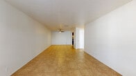 This 690 square foot apartment offers a thoughtful layout designed for comfortable single living. The space features a diverse mix of flooring, with warm wood-look flooring in the bedroom and durable tile in the living areas and bathroom. The living room is spacious and bright, with a large window allowing natural light to flood the space. A ceiling fan adds both style and functionality.

The modern bathroom boasts clean white fixtures, including a combination tub and shower, and a practical built-in shelving unit for storage. The kitchen is well-equipped with stainless steel appliances, ample dark wood cabinetry, and a convenient washer and dryer closet.

The bedroom, measuring 160 square feet, features a large window and a spacious closet with sliding doors. Throughout the apartment, neutral wall colors create a blank canvas for personalization. The overall design emphasizes efficiency and functionality, making the most of the available space while maintaining an open and airy feel. This apartment in Summit West - 21E - A1 strikes a balance between comfort and practicality, ideal for those seeking a low-maintenance yet stylish living space.