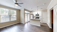 Located at 306 Ardmore Circle NW in Atlanta, GA, this one-bedroom, one-bathroom residence offers a thoughtfully designed layout with modern finishes throughout. The kitchen serves as a standout centerpiece, featuring a large granite-topped island with an integrated sink, crisp white cabinetry, a classic subway tile backsplash, and stainless steel appliances including a refrigerator, range, and microwave. Pendant and track lighting add a polished, contemporary touch, while a window provides a view to the outside. Wood-style flooring flows seamlessly throughout the space, complementing the neutral warm-beige tones on the walls. Crown molding in the living area lends an elegant detail, and a ceiling fan with natural light from a large window creates a bright, airy atmosphere. The bedroom is a comfortable retreat, also featuring a ceiling fan and a closet for ample storage. The bathroom is clean and functional, offering a tub-shower combination with white tile surround, a granite-topped vanity with white cabinetry, and a well-lit mirror. A dedicated closet rounds out the floorplan, providing practical storage solutions. The overall ambiance is clean, modern, and move-in ready.