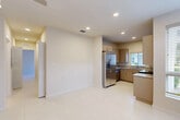 Located at 624 NE 2nd St in Dania Beach, Florida, this single-story residence offers a well-organized 2-bedroom, 2-bathroom floor plan designed for comfortable everyday living. Large-format porcelain tile flooring runs consistently throughout the entire home, creating a clean, cohesive aesthetic that reflects Florida's bright, coastal character.

The open living area flows seamlessly into a functional kitchen equipped with stainless steel appliances, including a French door refrigerator with ice maker, a range, and a built-in microwave. Warm taupe cabinetry pairs with granite countertops and a double basin sink positioned beneath a window that brings in natural light. Recessed lighting complements the kitchen's modern, efficient layout.

The primary bedroom is a generously sized retreat featuring a ceiling fan and sliding glass doors that open to an outdoor area, allowing for natural ventilation and light. The second bedroom also benefits from natural light through a window with outdoor views of greenery. Both rooms share access to two full bathrooms, one of which features a tiled tub-shower combination with granite vanity countertops.

Two closets provide practical storage, and the neutral color palette throughout creates a bright, airy ambiance well-suited to the South Florida climate.