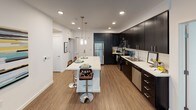 Located at 743 Montague Expressway in Milpitas, California, this single-floor residence offers a thoughtfully designed layout with modern finishes throughout. The open-concept kitchen serves as a central highlight, featuring dark espresso cabinetry extending to the ceiling, white quartz countertops, stainless steel appliances, and wood-look flooring. A large center island with pendant lighting and bar seating connects seamlessly to the living and dining areas, making it well-suited for entertaining. The living area is bright and comfortable, with a window fitted with blinds that allows natural light to filter in. The primary bathroom includes a dual-sink vanity with dark cabinetry, stone countertops, and wood-look flooring, with a walk-in closet visible beyond. A secondary bathroom features a combined tub and shower with a curved curtain rod and tile surround. The bedrooms are carpeted and well-lit by natural light through windows with exterior views of the surrounding community. A dedicated office space provides a quiet area with a window view, adding functional versatility to the floor plan. The overall aesthetic is clean and contemporary throughout.