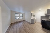 Located at 5726 N Winthrop Ave in Chicago's vibrant Edgewater neighborhood, this one-bedroom, one-bathroom unit offers a well-designed layout with modern updates throughout. The combined living and dining area greets you with warm hardwood-style flooring, crisp white walls, and a window that invites natural light into the space. A baseboard heating system runs along the perimeter, ensuring comfort year-round. The galley-style kitchen is thoughtfully appointed with gray shaker cabinets, a light quartz countertop, stainless steel appliances including a refrigerator and electric range, a stainless steel sink, and a decorative subway tile backsplash with an accent mosaic border — providing both style and practicality. A hallway connects the main living area to the private bedroom, which features a ceiling fan with light fixture, a window, baseboard heating, and two generous closets with bifold doors, offering ample storage. The full bathroom is finished with classic white subway tile surrounding the tub and shower, a white vanity, and polished chrome fixtures, creating a clean and timeless aesthetic. With two closets and a dedicated hallway, this unit maximizes every inch of its compact footprint efficiently.