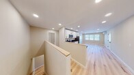 Located at 23 Prentice Street in North Grafton, MA, this thoughtfully updated two-floor space showcases a clean, modern aesthetic with carefully selected finishes throughout. Light hardwood flooring flows seamlessly across both levels, creating a warm and cohesive feel throughout the interior.

The kitchen is a standout feature, equipped with crisp white shaker-style cabinetry, dark granite countertops, and a full suite of stainless steel appliances including a refrigerator, electric range, microwave, and dishwasher. Recessed lighting illuminates the space efficiently, while an open layout connects the kitchen to the main living area, which benefits from natural light through multiple windows with views of the surrounding neighborhood.

The bedrooms are well-proportioned and bright, each featuring hardwood floors, large windows, and wall-mounted mini-split HVAC units for individual climate control. The bathrooms are finished with elegant marble-look tile flooring, white cabinetry with dark countertops, and matte black hardware accents, lending a contemporary and polished touch. A staircase with a light wood railing connects the two floors, adding to the open, airy flow of the layout. The overall design is clean, functional, and move-in ready.