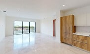 This contemporary apartment, located at 701 Valencia in Coral Gables, Florida, offers a generous 1390 square feet of living space on a single floor. The layout comprises three bedrooms, including a spacious primary bedroom of 230 square feet, and three full bathrooms. The open-concept design is accentuated by light-filled spaces and sleek, modern finishes.

The heart of the home features a bright, airy living area with polished marble flooring that extends throughout the apartment. The kitchen boasts wooden cabinetry in warm tones, contrasting beautifully with white upper cabinets and a neutral backsplash. High-end appliances and ample counter space make it ideal for culinary enthusiasts.

Each bedroom is well-proportioned, with the primary suite offering a luxurious retreat. The bathrooms are elegantly appointed, featuring floating vanities, large mirrors, and modern fixtures. Two closets provide ample storage space, with built-in shelving systems for organization.

Large windows in the bedrooms offer picturesque views of the surroundings, flooding the spaces with natural light. The neutral color palette throughout creates a calm, sophisticated ambiance, allowing for versatile decorating options. Recessed lighting and stylish fixtures add to the overall modern aesthetic of this meticulously designed Coral Gables residence.