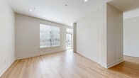 Located at 2901 Indiana St in Dallas, Texas, this single-floor unit offers a thoughtfully designed layout encompassing a combined kitchen and living area, a hallway, and a full bathroom. Light wood-style flooring runs consistently throughout the space, complementing the neutral, warm-toned walls and creating a cohesive, modern aesthetic.

The kitchen is a standout feature, equipped with stainless steel appliances including a refrigerator, range, microwave, and dishwasher. Two-tone cabinetry — navy blue lower cabinets paired with crisp white upper cabinets — adds a bold, contemporary touch, while light quartz countertops provide ample workspace. A kitchen island with an under-mount sink and a flexible pull-down faucet serves as both a functional prep area and a natural divider between the kitchen and living space.

The living area is bright and open, benefiting from natural light through a large window fitted with blinds, as well as a glass door that opens to an outdoor area, enhancing the sense of space and connectivity to the exterior.

The bathroom continues the modern design language with navy cabinetry, quartz countertops, brushed nickel hardware, and a full tub-shower combination framed by white subway tile. Recessed lighting throughout the unit provides clean, consistent illumination, completing the polished, move-in-ready feel of this Dallas residence.