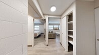 Located at 311 North Ottawa Street in Joliet, IL, this 2-bedroom, 1-bathroom unit offers a functional and modern living experience across a single floor. The interior showcases a consistent design language throughout, with light wood-style flooring, painted block walls, and neutral tones that create a clean, contemporary ambiance.

The living room is a bright, welcoming space featuring multiple windows with horizontal blinds that allow natural light to filter in. A wall-unit air conditioner and baseboard heating ensure year-round comfort. The open sightlines from the hallway into the living area reinforce the efficient, flowing layout of the unit.

The kitchen is well-equipped with white shaker-style cabinetry, granite countertops, a classic subway tile backsplash, and stainless steel appliances including a range, microwave, and full-size refrigerator — offering both style and practicality.

The primary bedroom features painted block accent walls, wall-mounted lighting, a closet, and a window with natural light. The second bedroom mirrors this design with its own window and ample space. A hallway closet with built-in shelving provides additional storage.

The bathroom is finished with a marble-top vanity, a large-format marble-style tile shower wall, wood-look flooring, and a wall-mounted toilet, delivering a polished and modern aesthetic throughout.