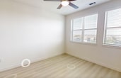 This 620-square-foot, one-bedroom, one-bathroom apartment in South Austin delivers a clean, modern aesthetic across a well-planned single-floor layout. The open-concept kitchen and living area serves as the heart of the unit, featuring a two-tone cabinet design with crisp white uppers and warm wood-grain lowers, white quartz countertops, a subway tile backsplash, and a full suite of stainless steel appliances including a French door refrigerator, electric range, built-in microwave, and dishwasher. A white kitchen island with pendant lighting above adds both prep space and casual dining functionality. Light wood-tone luxury vinyl plank flooring flows consistently throughout the unit, enhancing the bright, airy atmosphere. The 130-square-foot primary bedroom features a ceiling fan with light, a natural light-filled window with exterior views, and two separate doors leading to the closet and bathroom. The bathroom is appointed with dark wood-grain cabinetry, a white countertop vanity, a soaking tub with tiled surround, and light flooring that ties seamlessly to the rest of the unit. A dedicated closet provides additional storage. The overall design emphasizes a neutral, contemporary palette suited for modern urban living.