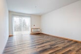 Located at 1070 N Pleasant View Rd in Madison, WI, this one-bedroom, two-bathroom unit offers a practical and well-organized single-floor layout. The open-concept kitchen and living area forms the heart of the space, where warm-toned hardwood-style flooring extends throughout. The kitchen features honey-toned wood cabinetry, light countertops, a peninsula with a sink, and white appliances including a refrigerator, range, microwave, and dishwasher. The adjoining living area is bright and airy, highlighted by a sliding glass door with vertical blinds that opens to an outdoor view of mature trees, allowing natural light to fill the room. A wall-mounted HVAC unit provides climate control in the living space. The bedroom is carpeted for comfort and includes a ceiling fan, a window with vertical blinds offering natural light and outdoor views, and a baseboard heater. Both bathrooms continue the warm wood aesthetic with matching cabinetry and hardwood-style flooring. One bathroom features a vanity with dual medicine cabinet mirrors, while the other includes a full tub-shower combination. A dedicated closet provides additional storage. Warm wood trim accents throughout tie the entire space together cohesively.