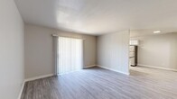 Located at 1818 W 700 N in Salt Lake City, Utah, this single-floor unit offers four bedrooms, one bathroom, a kitchen, a hallway, and an in-unit laundry area — all efficiently arranged within a compact, well-utilized footprint. Light-toned luxury vinyl plank flooring runs throughout, lending a clean and cohesive look to every room.

The living area features a large sliding glass door with vertical blinds, allowing natural light to fill the space. It flows seamlessly into the kitchen, which is equipped with white shaker-style cabinetry, dark granite countertops, a stainless steel dishwasher and refrigerator, and an electric range — all thoughtfully arranged for efficient use of space.

Each bedroom is finished with the same LVP flooring and neutral wall tones, with several rooms featuring ceiling fans and windows with blinds that bring in natural light and outdoor views. Closet space is provided, including a walk-in closet in the primary bedroom with a full hanging rod system.

The bathroom is well-appointed with a dark granite vanity top, white cabinetry, a full tub-shower combo, and matching LVP flooring. The dedicated laundry area accommodates a full-size side-by-side washer and dryer. Overall, the unit presents a clean, updated aesthetic throughout.
