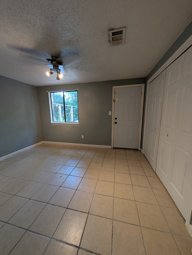 Down stairs bedroom with large closet and back yard exit. - 2228 Sandpiper St
