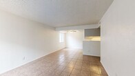 Located at 2540 W Maryland Ave in Phoenix, Arizona, this single-floor, 2-bedroom, 1-bathroom home offers a functional and straightforward layout. The open living and dining area is finished with neutral-toned tile flooring that extends throughout the home, creating a cohesive look. A ceiling fan is centrally positioned over a recessed section of the living area, and a window allows natural light to fill the space. The front entry opens directly into the living area, which connects seamlessly to the dining space and kitchen.

The galley-style kitchen features gray cabinetry on both sides, white appliances including a range and refrigerator, a single-basin sink with a light countertop, and track lighting overhead. A pass-through opening connects the kitchen to the dining and living areas.

Both bedrooms are well-proportioned, with tile flooring, white walls, textured ceilings, and windows fitted with vertical blinds. The primary bedroom includes its own door and benefits from natural light. A dedicated closet provides additional storage.

The bathroom is clean and practical, featuring a single-sink vanity with a light countertop, a wall mirror, a toilet, and a full tub/shower combo with a curtain rod. Tile flooring completes the space, maintaining the consistent aesthetic found throughout the home.