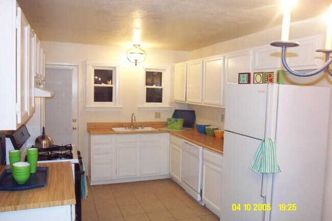 Kitchen with the old butcher block countertops (now quartz) and old appliances (now stainless steel) - 24606 University Ave