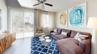 This contemporary condo in Las Vegas offers a well-designed living space spread across two floors. The 1010 square foot property features a single bedroom and bathroom, with the primary bedroom occupying a generous 340 square feet. The ground floor, measuring 540 square feet, houses the main living areas, while the upper floor spans 470 square feet.

The heart of the home is the modern kitchen, showcasing sleek wooden cabinetry, stainless steel appliances, and a spacious granite-topped island with bar seating. The open-concept design seamlessly integrates the kitchen with the living room, creating an ideal space for entertaining. The living area is adorned with a plush sectional sofa, vibrant artwork, and a bold blue geometric rug, adding character to the neutral palette.

The bedroom is a tranquil retreat, featuring a tufted upholstered bed frame, contemporary artwork, and a ceiling fan for comfort. The bathroom continues the modern aesthetic with a granite countertop, wooden vanity, and a shower with a stylish patterned curtain.

Throughout the condo, hardwood flooring adds warmth and continuity. Large windows and sliding glass doors invite natural light, while thoughtful lighting fixtures provide ambiance. The property also includes a dedicated closet space with built-in shelving and hanging rods for organization.

Attention to detail is evident in the decor, with carefully chosen accessories and artwork that complement the overall design. The result is a harmonious blend of style and functionality in this compact yet well-appointed urban dwelling.