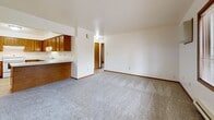 Located on W Cold Spring Rd in Greenfield, WI, this 2-bedroom, 1-bathroom unit offers a practical and comfortable single-floor layout. The living room is bright and generously sized, featuring plush wall-to-wall carpeting, a large picture window that fills the space with natural light and outdoor views, and a wood-trimmed entry door. Baseboard heating runs throughout, ensuring consistent warmth year-round.

The kitchen opens directly to the living area via a peninsula counter, creating a connected and functional flow between spaces. It features warm honey-toned wood cabinetry with ample upper and lower storage, light countertops, stone-look tile flooring, and a full suite of white appliances including a refrigerator, electric range, and dishwasher.

Both bedrooms are carpeted and finished with neutral walls and wood trim baseboards. The primary bedroom offers a spacious double sliding-door closet, while the second bedroom includes a window with outdoor views and baseboard heating. The full bathroom is clean and well-appointed, featuring a wood-toned vanity with a white countertop sink, a large mirror, a full tub-shower combo, and stone-look tile flooring consistent with the kitchen.