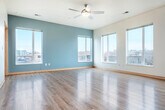 Located at 640 W Wilson St in Madison, WI, this well-appointed 2-bedroom, 2-bathroom unit offers a thoughtfully designed open-concept layout. The combined kitchen and living area serves as the heart of the home, featuring light hardwood-style flooring, a striking teal accent wall, and multiple windows that flood the space with natural light and urban views. A ceiling fan adds comfort to the generous living area.

The kitchen is a standout, outfitted with rich dark-wood cabinetry, a white quartz countertop island with stylish pendant lighting, a mosaic tile backsplash, and a full suite of stainless steel appliances including a range, microwave, dishwasher, and refrigerator.

Both bedrooms are carpeted and include ceiling fans and windows with outdoor views. The spacious primary bedroom benefits from its own access and ample room for furnishings. Two closets provide well-organized storage, including a walk-in closet with built-in wire shelving. The two bathrooms are finished with dark wood vanities, white quartz countertops, large mirrors, and clean, neutral tiling. The overall aesthetic is modern and cohesive, combining functional design with contemporary finishes throughout.
