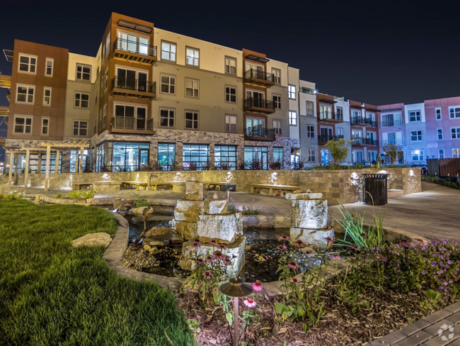 1505 Apartments Exterior Pond View At Night - 1505 Apartments + Townhomes