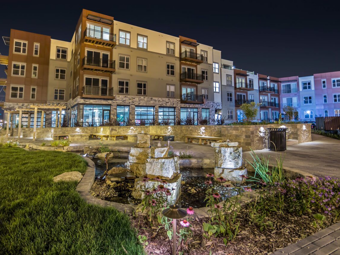 1505 Apartments Exterior Pond View At Night - 1505 Apartments + Townhomes