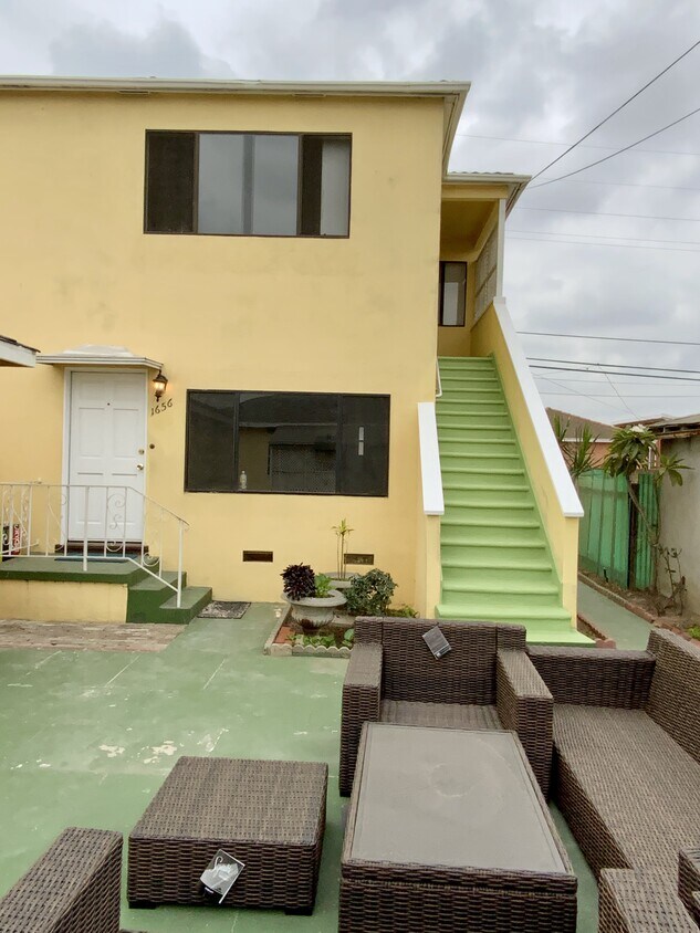 The outside. The unit is the downstairs unit. There is a courtyard common area outside. - 1656 W 107th St