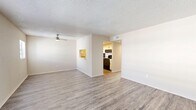 Located at 4216 S Manhattan Ave in Tampa, FL, this single-floor, 2-bedroom, 2-bathroom residence offers a clean and functional layout with a consistent, modern aesthetic throughout. Light wood-style luxury vinyl flooring runs across the main living areas and bedrooms, creating a cohesive and easy-to-maintain interior. Textured ceilings and neutral warm-toned walls provide a bright, airy atmosphere throughout the home.

The combined dining and living area is generously proportioned, featuring a ceiling fan and a pass-through window that connects to the kitchen, adding an open and communicative feel. The kitchen is equipped with dark cabinetry and black appliances, offering practical storage and workspace. A hallway connects the living areas to the private quarters.

Both bedrooms include ceiling fans and windows that invite natural light. The primary bedroom features a closet and direct access to its en-suite bathroom. The second bedroom also benefits from natural light through a window. Three closets distributed throughout the unit provide ample storage.

Both bathrooms are finished with white vanities and full tub-shower combinations. Wood-style flooring in the bathrooms ties the design together. A dedicated utility room rounds out the layout, enhancing everyday practicality. The home's overall design is clean, neutral, and move-in ready.