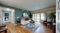Located at 451 Westcliffe Blvd in Richland, WA, this thoughtfully designed single-floor residence offers three bedrooms, two bathrooms, and a dedicated office space. The open-concept living area immediately draws the eye with warm hardwood flooring, a bold teal accent wall, and a large sliding glass door that bathes the space in natural light while framing lush outdoor greenery. A decorative wall shelf and mirror add character to the living room, which flows seamlessly into the dining area, where hardwood floors continue underfoot.

The kitchen is sleek and functional, featuring white cabinetry with modern hardware, light countertops, stainless steel appliances, and a dedicated pantry — all complemented by the same warm hardwood flooring. The primary bedroom is carpeted for comfort and includes a closet with wire shelving, while additional bedrooms offer similar cozy finishes and natural light. The office is a bright, versatile space with carpet flooring and multiple windows overlooking the outdoors. The bathrooms are clean and well-appointed, with a tub-shower combination. Throughout the home, neutral tones and consistent flooring choices create a cohesive, welcoming ambiance suited for everyday living.