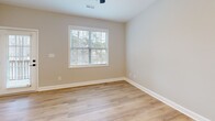 Located at 3374 Starboard Way in Fayetteville, NC, this two-story home offers a thoughtfully designed layout spread across two floors. The exterior presents a modern aesthetic with board-and-batten siding, a clean driveway, and fresh landscaping.

The main floor features an open-concept living, dining, and kitchen area, all connected by light-toned luxury vinyl plank flooring. The kitchen is well-appointed with crisp white shaker cabinetry, gold hardware, stainless steel appliances including a range, microwave, dishwasher, and refrigerator, and bright white countertops. A pantry provides additional storage, and the bathrooms on this level continue the gold-accented design theme, including a powder room with a pedestal sink and oval mirror. The attached garage offers convenient direct access.

Upstairs, the home provides three bedrooms, including a spacious primary suite with plush carpet, a ceiling fan, natural light from a window, a walk-in closet, and an en-suite bathroom featuring a white vanity with gold fixtures. The secondary bedrooms each include closets and soft carpeting. All three bathrooms maintain a cohesive, contemporary style with white finishes and warm gold hardware. A dedicated laundry area and ample closet space throughout add to the home's practicality.