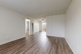 This single-floor, 3-bedroom, 1-bathroom home in Riverside, California offers a practical and well-maintained layout. The open living room and kitchen area serves as the heart of the home, featuring rich dark wood-style flooring, crisp white walls, a textured ceiling, and a ceiling fan that enhances airflow and comfort. Natural light filters in through a patio-facing window and door, creating a bright and welcoming atmosphere.

The kitchen is efficiently designed in a U-shape, outfitted with white cabinetry, granite-style countertops, a white range, and wood-style flooring that ties seamlessly into the living area. A window with vertical blinds allows natural light into the space.

The three bedrooms offer a comfortable retreat, with some featuring wall-to-wall carpet, closets with built-in hanging rods, and vertical blinds for light control. One bedroom includes a wall-mounted A/C unit for personalized climate control.

The bathroom is clean and functional, featuring a tiled tub-shower surround with earthy tones, a white vanity with granite-style countertop, and wood-style flooring. A hallway connects the bedrooms and bathroom, providing efficient flow throughout the home. The patio offers additional outdoor space, rounding out this well-appointed Riverside residence.