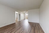 This single-floor, 3-bedroom, 1-bathroom home in Riverside, California offers a practical and well-maintained layout. The open living room and kitchen area serves as the heart of the home, featuring rich dark wood-style flooring, crisp white walls, a textured ceiling, and a ceiling fan that enhances airflow and comfort. Natural light filters in through a patio-facing window and door, creating a bright and welcoming atmosphere.

The kitchen is efficiently designed in a U-shape, outfitted with white cabinetry, granite-style countertops, a white range, and wood-style flooring that ties seamlessly into the living area. A window with vertical blinds allows natural light into the space.

The three bedrooms offer a comfortable retreat, with some featuring wall-to-wall carpet, closets with built-in hanging rods, and vertical blinds for light control. One bedroom includes a wall-mounted A/C unit for personalized climate control.

The bathroom is clean and functional, featuring a tiled tub-shower surround with earthy tones, a white vanity with granite-style countertop, and wood-style flooring. A hallway connects the bedrooms and bathroom, providing efficient flow throughout the home. The patio offers additional outdoor space, rounding out this well-appointed Riverside residence.
