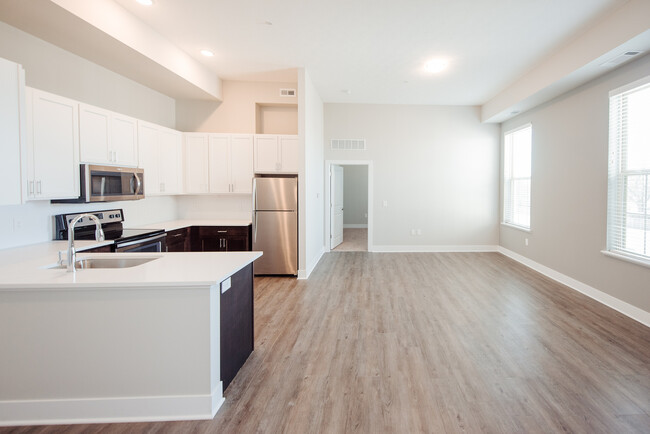 Experience contemporary living in this airy open-plan apartment with sleek kitchen design. - The Landon at New Albany Park